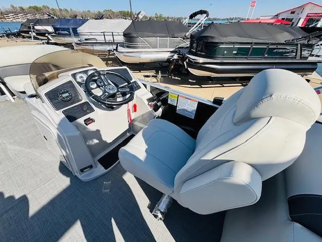 Slide: The Image of 2024 Sylvan Mirage 8522 LZ boat interior with steering wheel and captain's chair. - 13