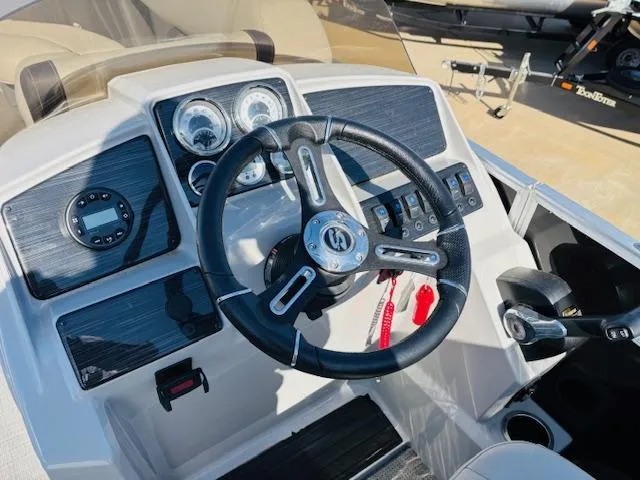 Slide: The Image of 2024 Sylvan Mirage 8522 LZ boat dashboard with steering wheel and control panel. - 14