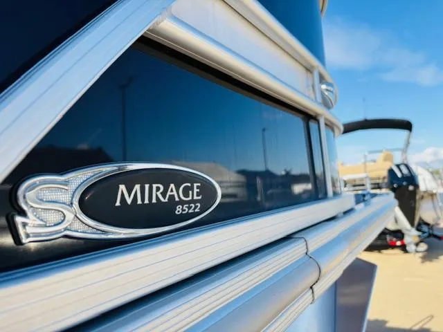 Slide: The Image of 2024 Sylvan Mirage 8522 LZ boat, close-up of model emblem, sunny day. - 23