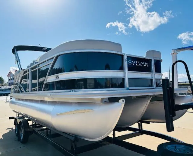 Slide: The Image of 2024 Sylvan Mirage 8522 LZ pontoon boat on trailer under clear sky. - 3