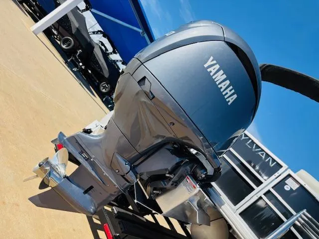 Slide: The Image of 2024 Sylvan Mirage 8522 LZ with Yamaha outboard motor, displayed outdoors. - 7