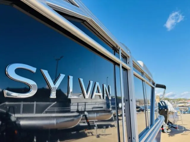 Slide: The Image of 2024 Sylvan Mirage 8522 LZ pontoon boat with sleek design and reflective finish. - 8