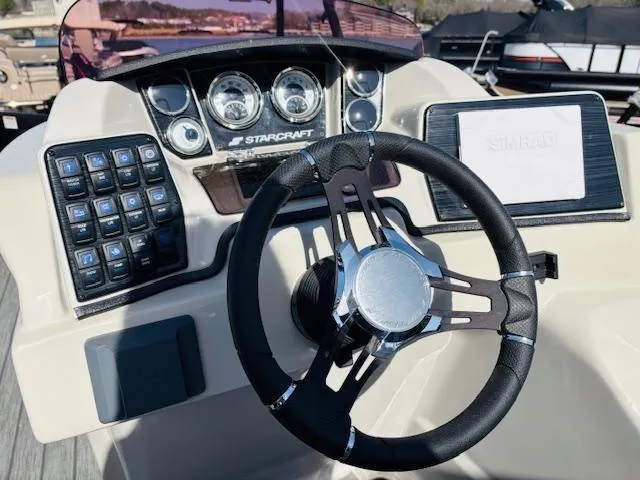 Slide: The Image of 2023 Starcraft SLS-5 Q DH boat dashboard with steering wheel and control panel. - 10