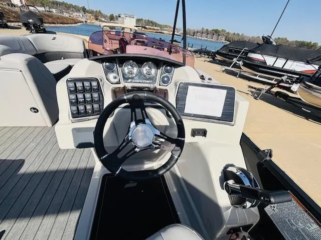 Slide: The Image of 2023 Starcraft SLS-5 Q DH boat dashboard with steering wheel and control panel. - 11