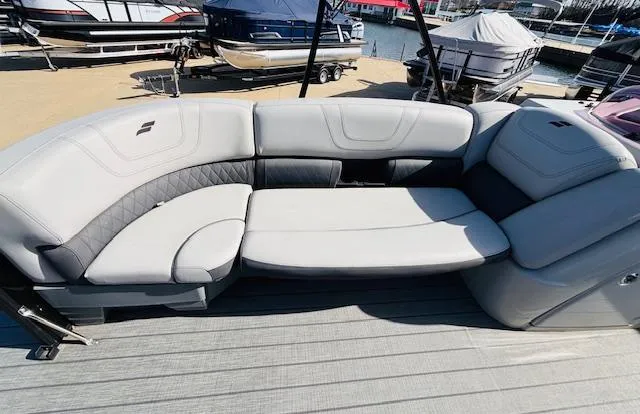 Slide: The Image of Luxurious seating on 2023 Starcraft SLS-5 Q DH boat, docked with other vessels. - 14