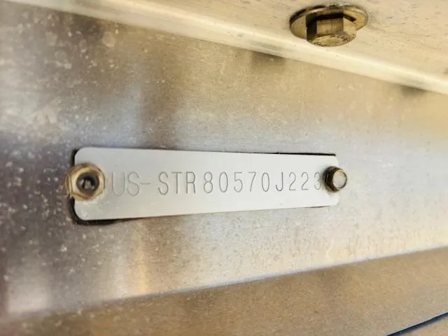 Slide: The Image of 2023 Starcraft SLS-5 Q DH identification plate with serial number, mounted on metal surface. - 23