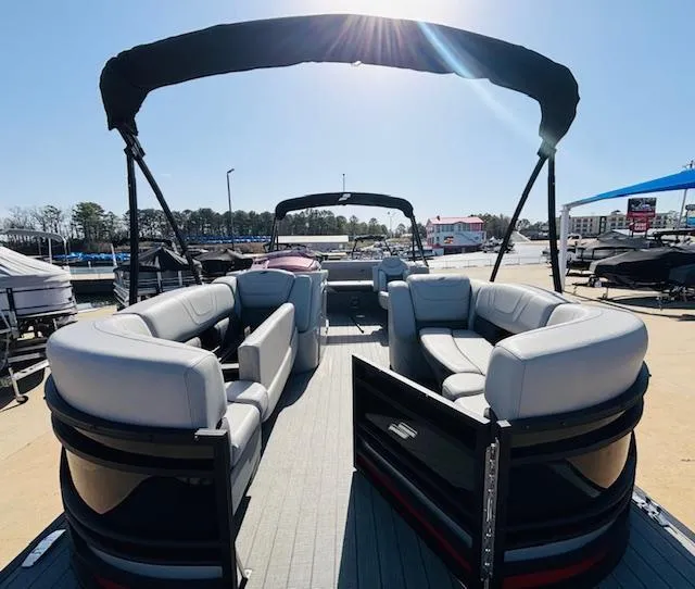 Slide: The Image of 2023 Starcraft SLS-5 Q DH pontoon boat with spacious seating and canopy, docked under sunlight. - 5