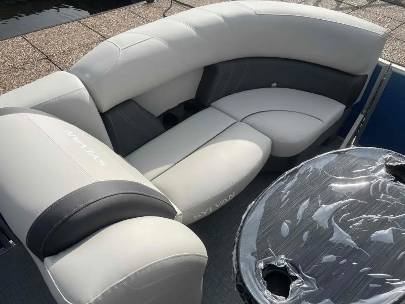 Slide: The Image of 2024 Sylvan MIRAGE 822 CLZ DH boat with luxurious seating and table. - 10