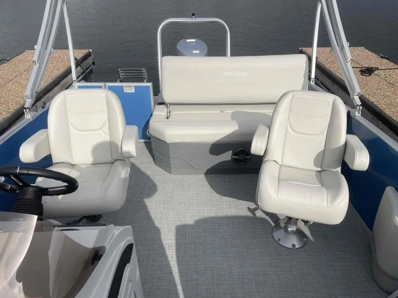 Slide: The Image of 2024 Sylvan MIRAGE 822 CLZ DH pontoon boat interior with white seating and steering console. - 11