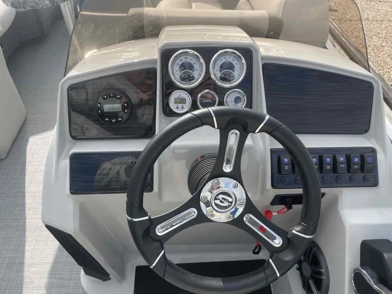 Slide: The Image of 2024 Sylvan MIRAGE 822 CLZ DH boat dashboard with steering wheel and gauges. - 13