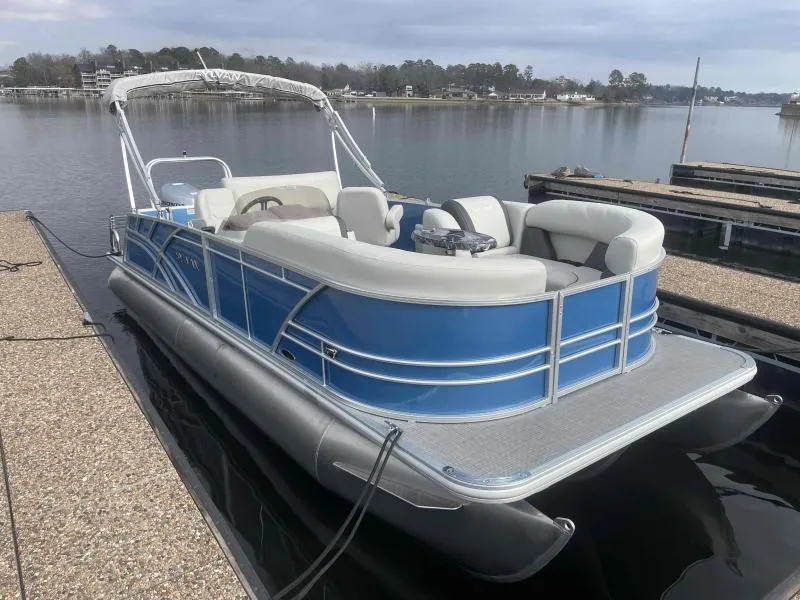 Slide: The Image of 2024 Sylvan MIRAGE 822 CLZ DH pontoon boat docked on a calm lake. - 3