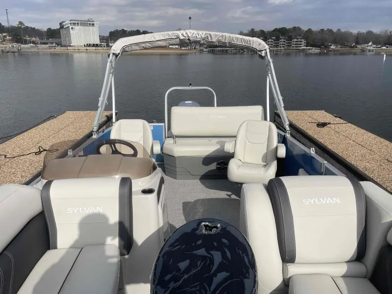 Slide: The Image of 2024 Sylvan MIRAGE 822 CLZ DH pontoon boat interior with seating and steering wheel. - 7