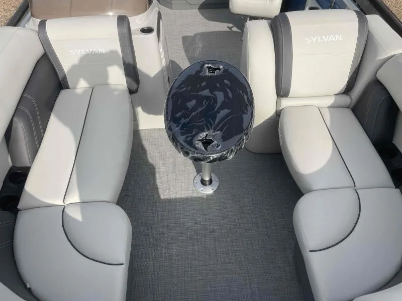 Slide: The Image of 2024 Sylvan MIRAGE 822 CLZ DH boat interior with gray seating and central table. - 8