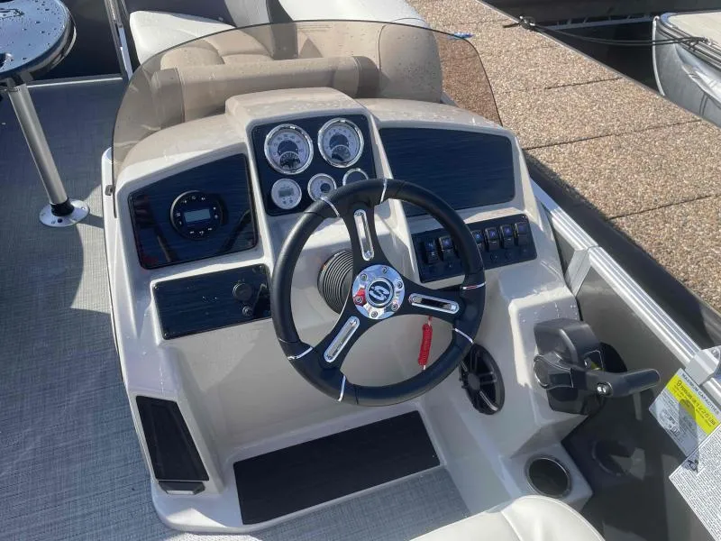 Slide: The Image of 2024 Sylvan MIRAGE 822 CLZ DH boat dashboard with steering wheel and control panel. - 14