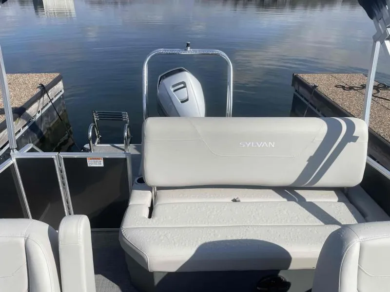 Slide: The Image of 2024 Sylvan MIRAGE 822 CLZ DH pontoon boat interior with seating and motor. - 16