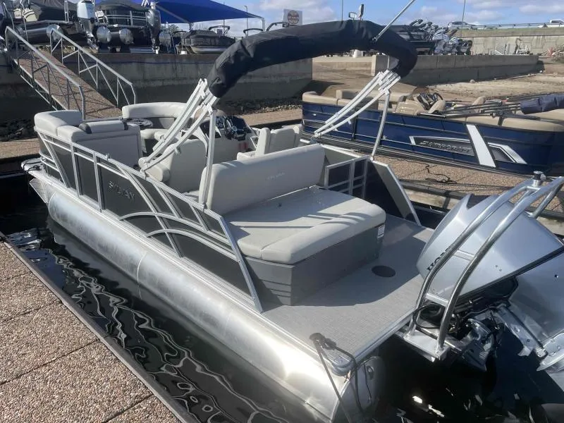 Slide: The Image of 2024 Sylvan MIRAGE 822 CLZ DH pontoon boat docked, featuring sleek design and comfortable seating. - 6