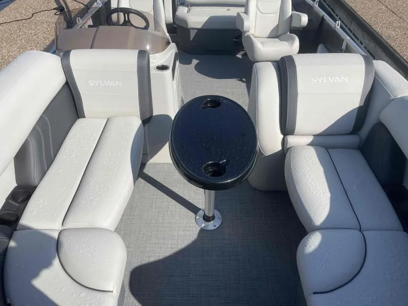 Slide: The Image of 2024 Sylvan MIRAGE 822 CLZ DH pontoon boat interior with gray seating and central table. - 8