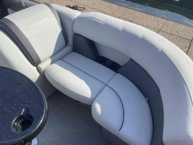 Slide: The Image of 2024 Sylvan MIRAGE 822 CLZ DH boat interior with wet seating and table. - 9