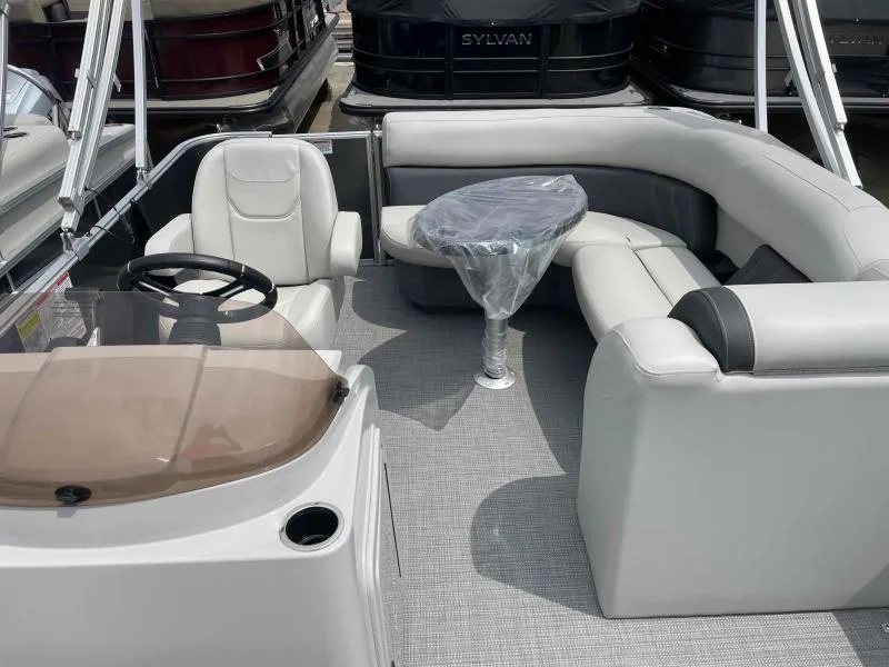 Slide: The Image of 2024 Sylvan Mirage 818 Fish boat interior with seating and steering wheel. - 11