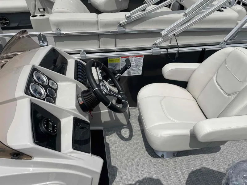 Slide: The Image of 2024 Sylvan Mirage 818 Fish boat interior with steering wheel and white captain's chair. - 13