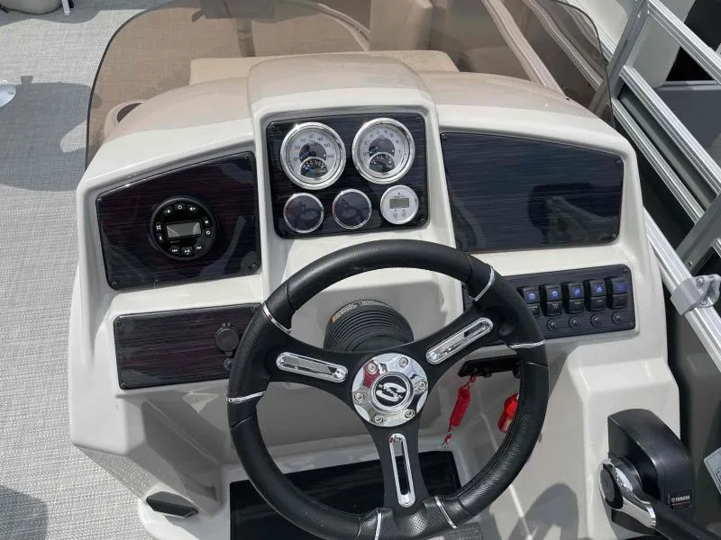 Slide: The Image of 2024 Sylvan Mirage 818 Fish dashboard with steering wheel and control panel. - 14