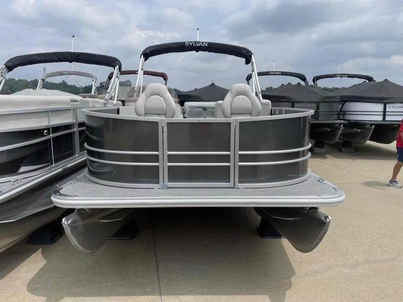 Slide: The Image of 2024 Sylvan Mirage 818 Fish pontoon boat displayed at a marina. - 2