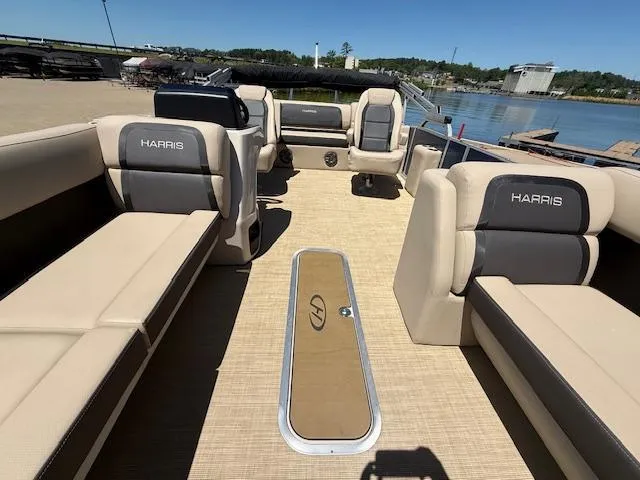 Slide: The Image of 2024 Harris HCX 25 Cruiser 250 pontoon boat interior with beige seating and lake view. - 10