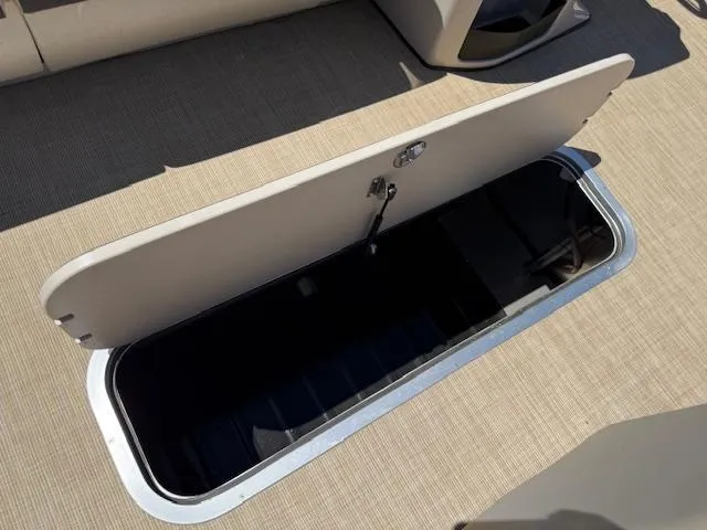 Slide: The Image of 2024 Harris Boats HCX 25 Cruiser 250 storage compartment, open on deck. - 11