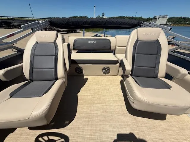 Slide: The Image of 2024 Harris Boats HCX 25 Cruiser 250 interior with beige and gray seating. - 12