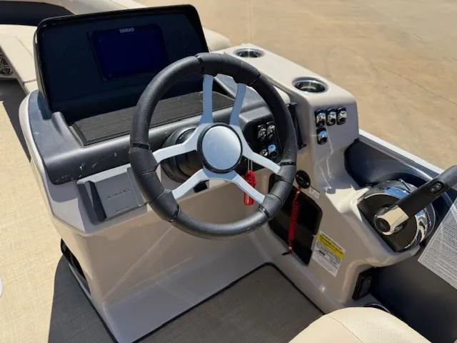 Slide: The Image of 2024 Harris Boats HCX 25 Cruiser 250 helm with steering wheel and control panel. - 15