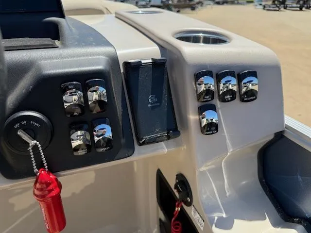 Slide: The Image of Control panel of 2024 Harris Boats HCX 25 Cruiser 250 with switches and key. - 16