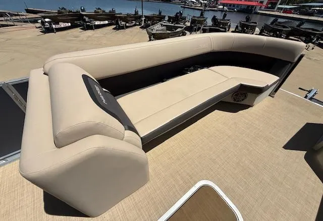 Slide: The Image of 2024 Harris Boats HCX 25 Cruiser 250 with beige seating on a sunny dock. - 19