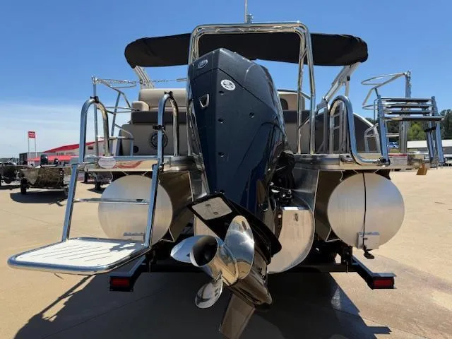 Slide: The Image of 2024 Harris Boats HCX 25 Cruiser 250, rear view with outboard motor and pontoons. - 6