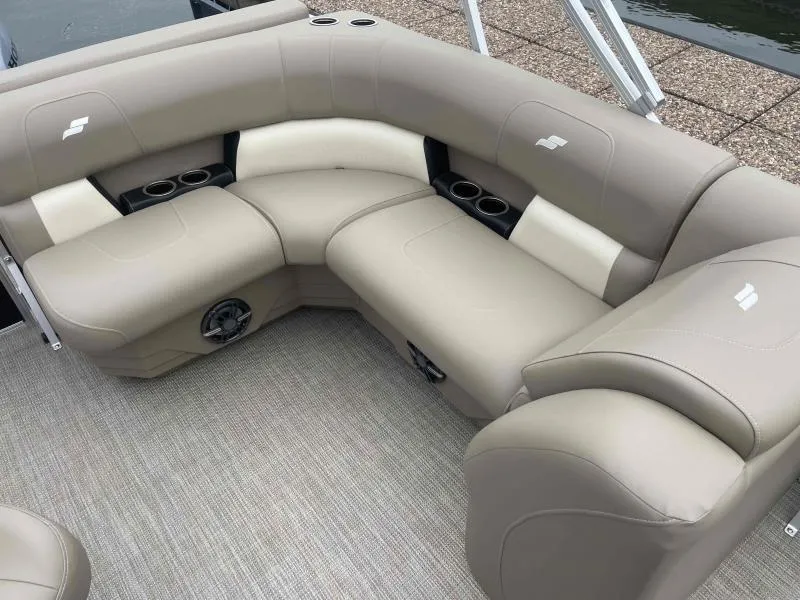 Slide: The Image of 2024 Starcraft LX 20 CB boat interior with beige seating and cup holders. - 10