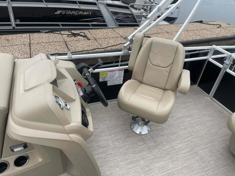 Slide: The Image of 2024 Starcraft LX 20 CB boat interior with beige captain's chair and control panel. - 12