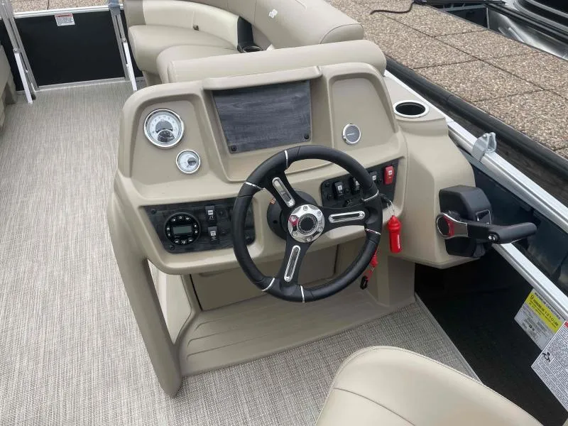 Slide: The Image of 2024 Starcraft LX 20 CB boat dashboard with steering wheel and control panel. - 13