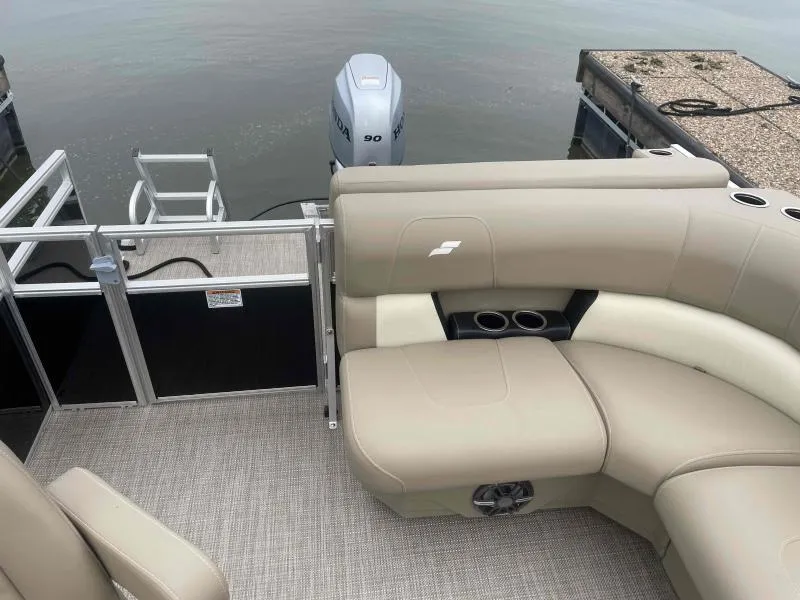 Slide: The Image of 2024 Starcraft LX 20 CB pontoon boat with beige seating and Honda outboard motor. - 14