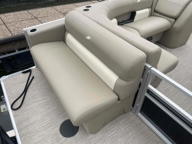 Slide: The Image of 2024 Starcraft LX 20 CB boat interior with beige seating and cup holders. - 15