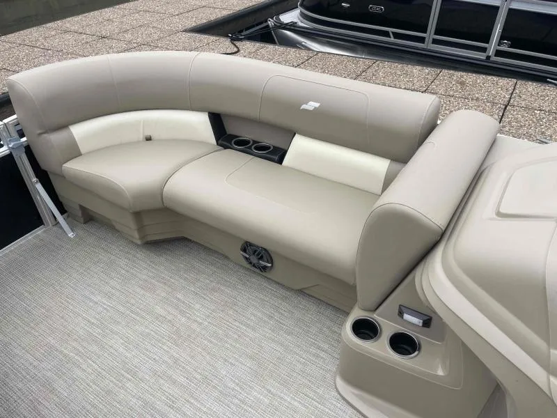 Slide: The Image of 2024 Starcraft LX 20 CB boat interior with beige seating and cup holders. - 9