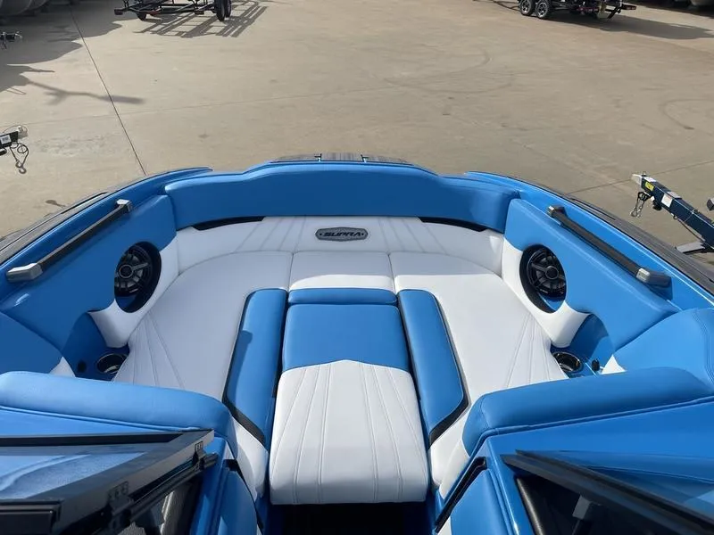 Slide: The Image of 2023 Supra SA 450 boat interior with blue and white seating and speakers. - 10