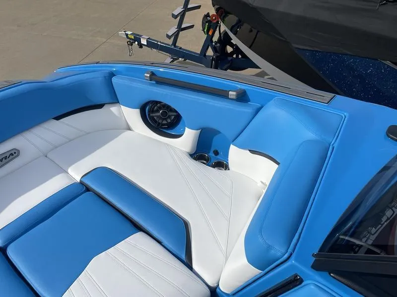 Slide: The Image of 2023 Supra SUPRA SA 450 boat interior with blue and white seating and speaker. - 12