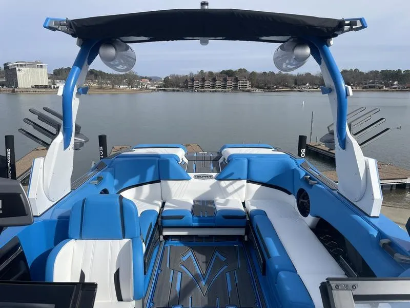 Slide: The Image of 2023 Supra SUPRA SA 450 boat with blue and white interior on a lake. - 13