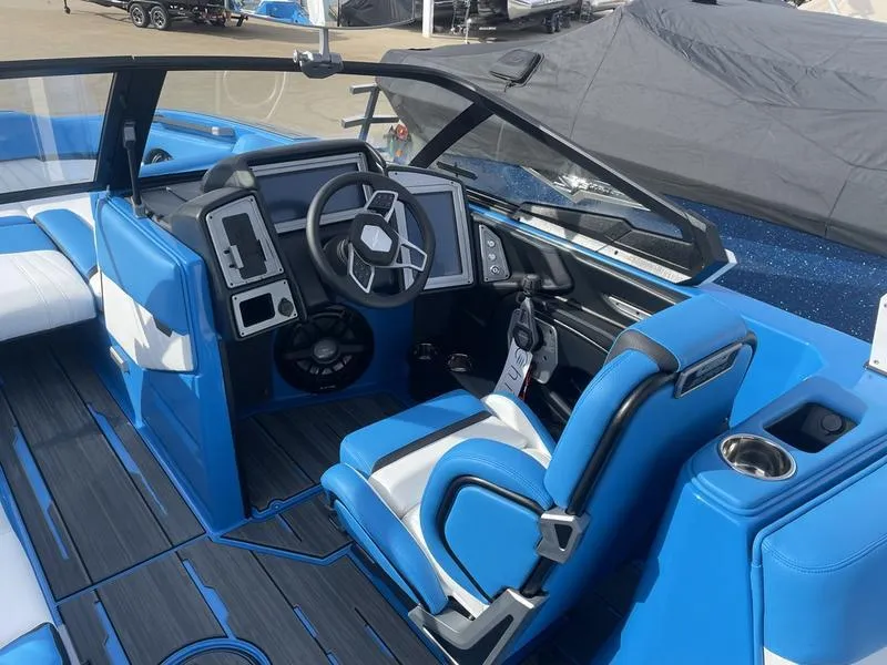 Slide: The Image of 2023 Supra SA 450 boat interior with blue and white seating and modern dashboard. - 15