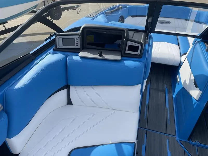 Slide: The Image of 2023 Supra SUPRA SA 450 boat interior with blue and white seating and dashboard. - 17