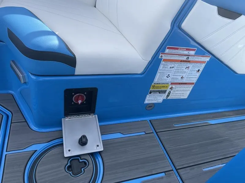 Slide: The Image of 2023 Supra SA 450 boat interior with blue and white seating and control panel. - 19