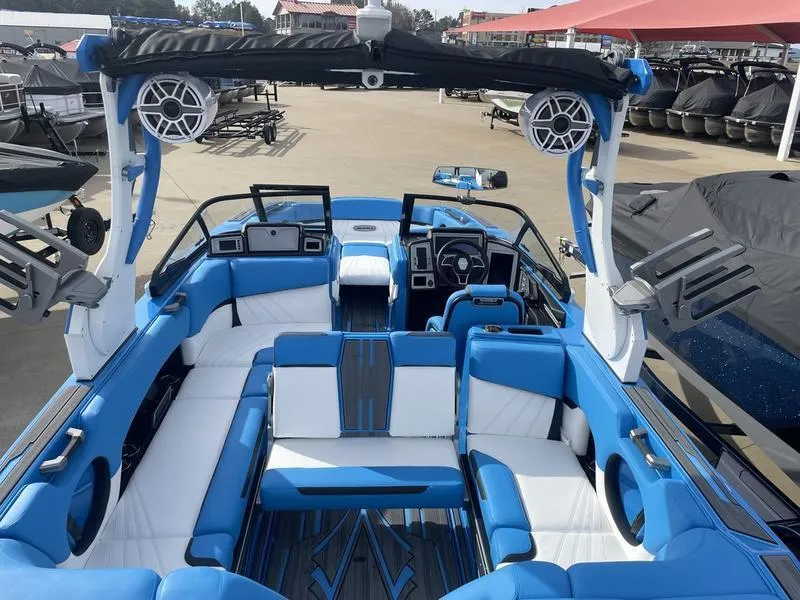 Slide: The Image of 2023 Supra SUPRA SA 450 boat interior with blue and white seating, advanced dashboard, and speakers. - 22