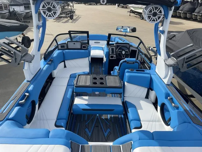 Slide: The Image of 2023 Supra SUPRA SA 450 boat interior with blue and white seating, modern design. - 23
