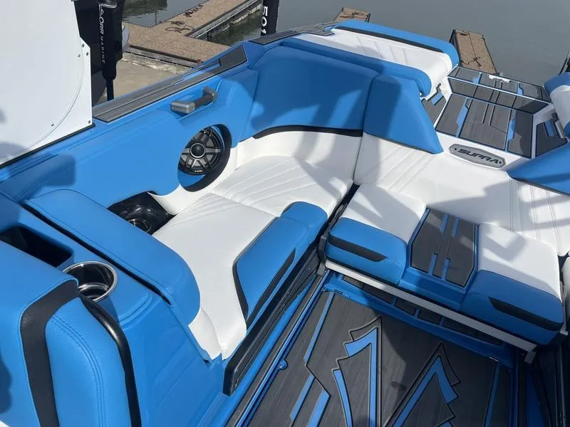 Slide: The Image of 2023 Supra SA 450 boat interior with blue and white seating and speaker system. - 25