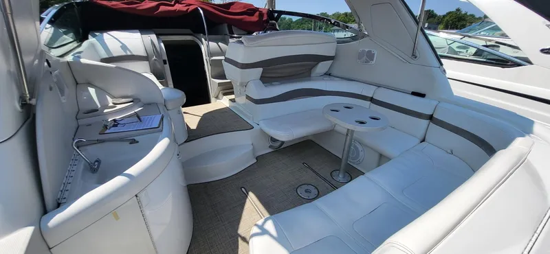 Slide: The Image of 2002 Formula 37 PC yacht interior with white seating and table, showcasing luxury design. - 10