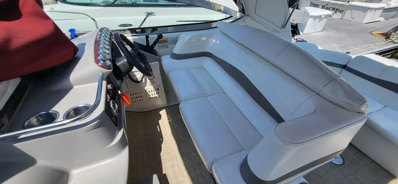 Slide: The Image of 2002 Formula 37 PC boat interior with white seating and steering console. - 11